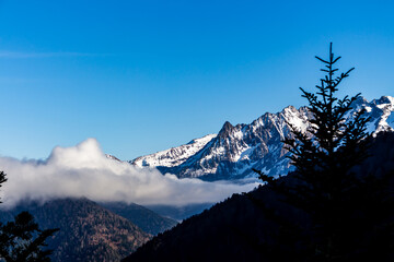 Snow and mountain peaks in the french Pyrenees near the Luchon Superbagnères Ski Resort in the Arrondissement of Saint-Gaudens, Occitania, Haute-Garonne, France. The Luchonnais Mountains aerial view.