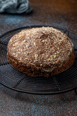 Homemade dark chocolate cake with shredded almond and desiccated coconut topping