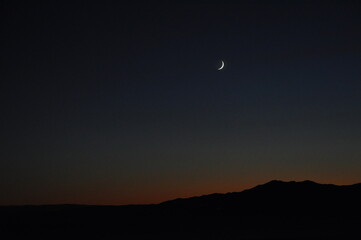 Beautiful night mountain and sky background with moon. Moon over the sea, photo as a background