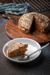 Homemade dark chocolate cake with shredded almond and desiccated coconut topping