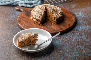 Homemade dark chocolate cake with shredded almond and desiccated coconut topping