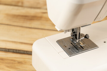Close-up of a white sewing machine and sewing machine feet . sewing and needlework, sewing on a sewing machine.
