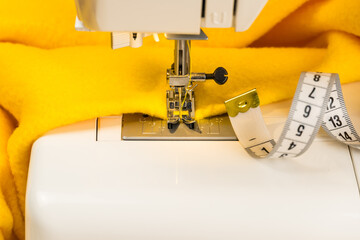 Sewing machine with cloth and tape measure. The concept of sewing clothes as a small business.