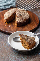 Homemade dark chocolate cake with shredded almond and desiccated coconut topping