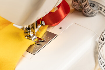 Sewing machine with cloth and tape measure. The concept of sewing clothes as a small business.