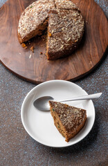 Homemade dark chocolate cake with shredded almond and desiccated coconut topping