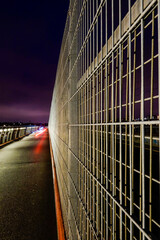 Stockholm, Sweden An abstract view of the fencing on the Arsta bridge at night