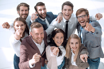 Obraz premium happy team of successful young business people pointing at you