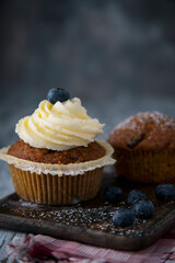 
Homemade cupcake and blueberries on a wooden table