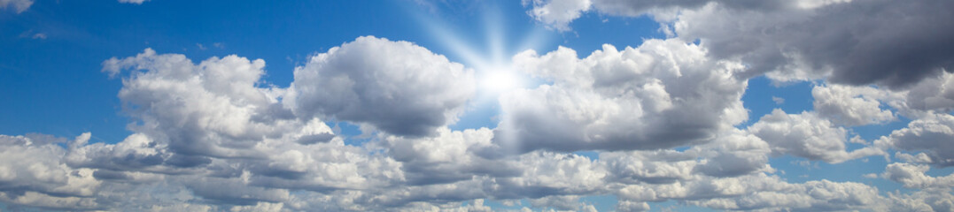 blue sky with white clouds and sun light. Nature background of sky