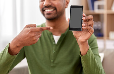 technology, internet, communication and people concept - close up of happy smiling indian man showing smartphone at home