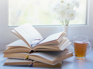 mug of hot tea and books