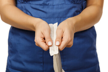 Woman doctor in blue coat opens paper packaging with disposable sterile rubber surgical gloves...