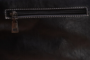 zipper on black leather. background for designer