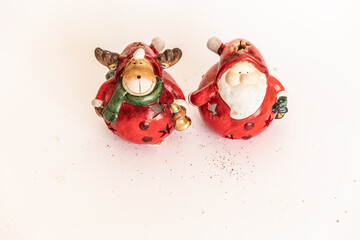 Christmas. New Year's jewelry. toy santa claus and deer on a white background.