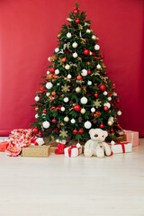 Christmas tree with gifts in the interer lights garland decor new year