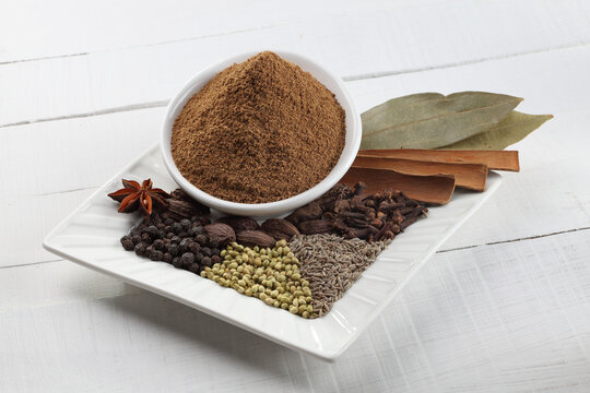 Ingredients of Indian garam masala in a white platter
