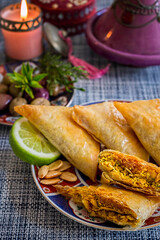 Parcels of Moroccan Savory Briouats With Spicy Chicken and Almonds on Traditional Moroccan Dish