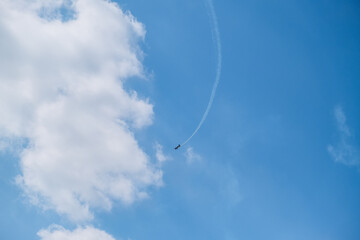 blue plane flying against a blue sky