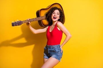 Fototapeta na wymiar Portrait of her she nice attractive lovely glad cheerful cheery wavy-haired girl carrying guitar chill rest live performance isolated bright vivid shine vibrant yellow color background