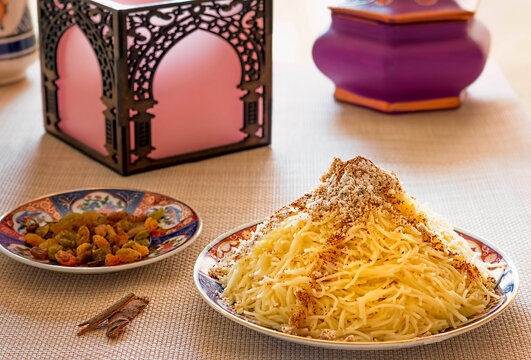 Moroccan Seffa with Angel Hair Pasta Sweetened with Sugar, Cinnamon and Almonds, presented on Traditional Decorated Dishes.