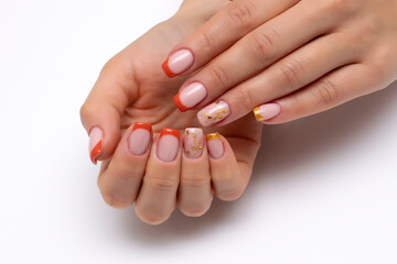 Autumn orange French manicure with golden tree and crystals on long square nails on a white background close up