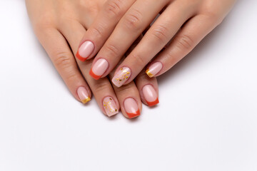 Autumn orange French manicure with golden tree and crystals on long square nails on a white background close up