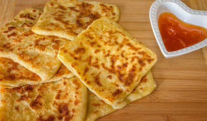 Traditional Moroccan Msemen puff pastry accompanied by peach jam. Rghaif, Meloui.