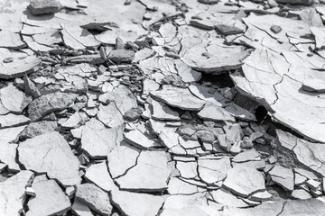 Cracked concrete texture background. Grey surface with cracks close up. A lot of pieces of...