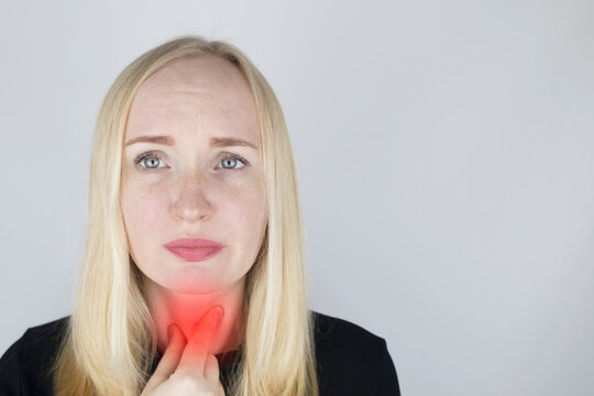 The doctor examines and feels the lymph nodes of the patient, who complains of pain and sore throat. The concept of medical care and diagnosis of coronavirus or influenza. On examination by a doctor.