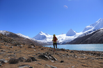 Woman trail runner cross country running  in winter mountains