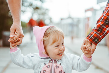 parents walk with a child holding hands