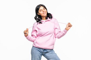 Portrait of a cheerful young woman showing peace gesture wearing hoodie standing isolated over...