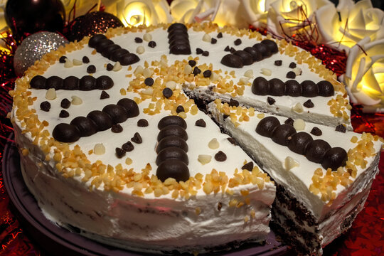 Delicious Vanilla Ice Cream Cake decorated with Black and White Chocolate and Almond. Christmas. Events