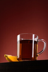 Glass mug of black hot tea with lemon. View from below
