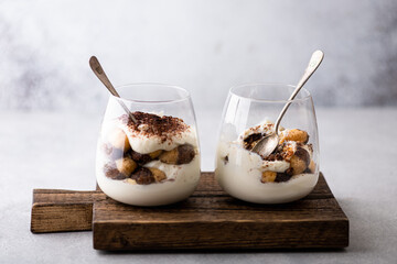 tiramisu dessert in a glass on a light background