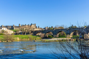Obraz premium The River Aude and Old Bridge (Pont Vieux, 14th Cent) leading to Medieval town of Carcassonne (Cité), Languedoc-Roussillon, France.