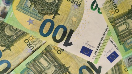 100 Euro banknotes close up. 100 euros are right in front of the camera, all the details are visible. Background for financial news with 100 euros.  Euro banknotes arranged abstractly.