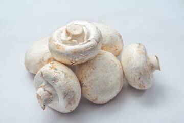 Fresh raw champignon mushrooms ready for cooking on the table. 