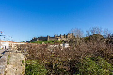 Fototapeta premium Carcassonne / France - March 11, 2020 - The Old Bridge (Pont Vieux, 14th Cent) leading to Medieval town of Carcassonne (Cité), Languedoc-Roussillon.