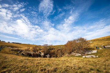 Fototapeta premium Entrance of the Grotta del Ciabattino (Cave of the Shoemaker). Jurassic, near the peak of Corno d'Aquilio on Lessinia Plateau, Verona province, Veneto, Italy, Europe.