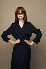 Luxurious model dark coat attractive appearance rejoicing on an isolated background 