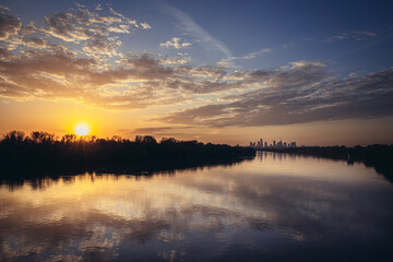 Sunset over Vistula River and city downtown in Warsaw, capital of Poland - sunset view from Siekierkowski Bridge