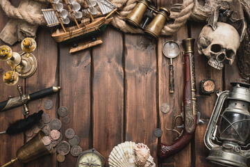 Pirate equipment and accessories on the ancient table concept background with copy space.