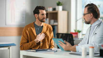 Doctor Consultation Office: Male Patient Describes Chest Pain to His Family Physician, Showing...