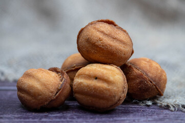 Delicious homemade cookies on the background of rough homespun fabric. Close-up, selective focus.