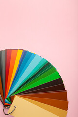 Colored cardboard palette, paper catalog on a pink background.