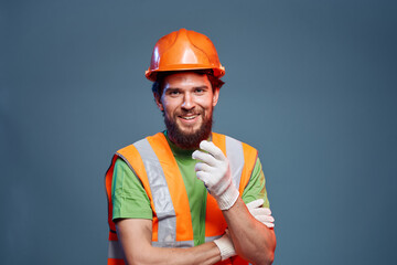 A man in a work uniform is a construction engineer. Industry Professional orange hard hat