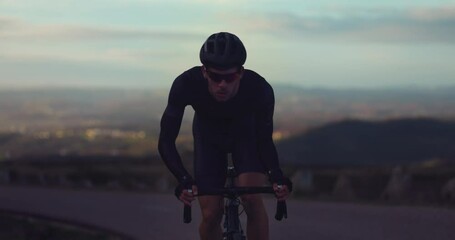 Professional cyclist riding bicycle on top of mountain at sunrise - Powered by Adobe