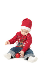 Baby in Santa hat playing with Christmas balls, isolated on white